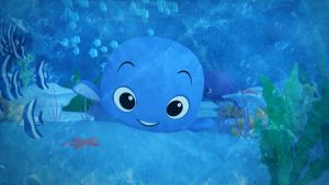 A scene from Artoonic featuring various characters, including a small whale