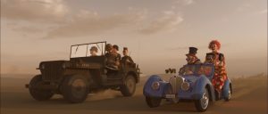 Frame from "Desert Racers" showing soldiers in a jeep and clowns in an Oldsmobile set against a desert backdrop.